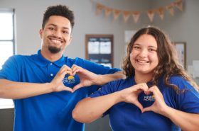 New Horizon Academy teachers making a heart shape with their hands