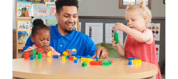 http://Male%20teacher%20playing%20blocks%20with%20toddler%20children%20to%20help%20them%20build%20math%20and%20fine%20motor%20skills