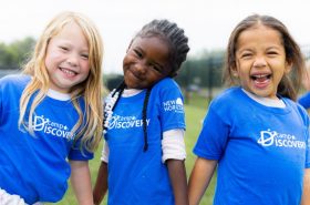 School-age children playing outside in New Horizon Academy's Camp Discovery summer program