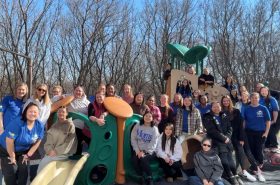 New Horizon Academy teachers gathered around playground at school in Maple Grove at Boston Scientific headquarters